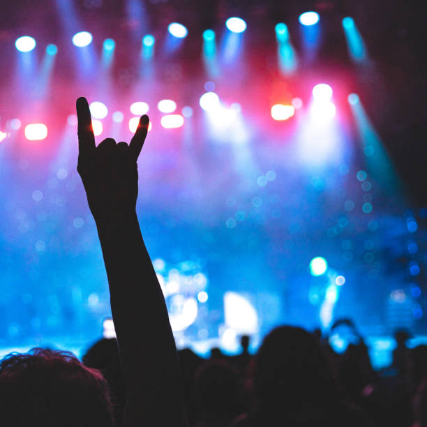 rock concert, concert hands raised, rock hands, rock on - concert stock pictures, royalty-free photos & images