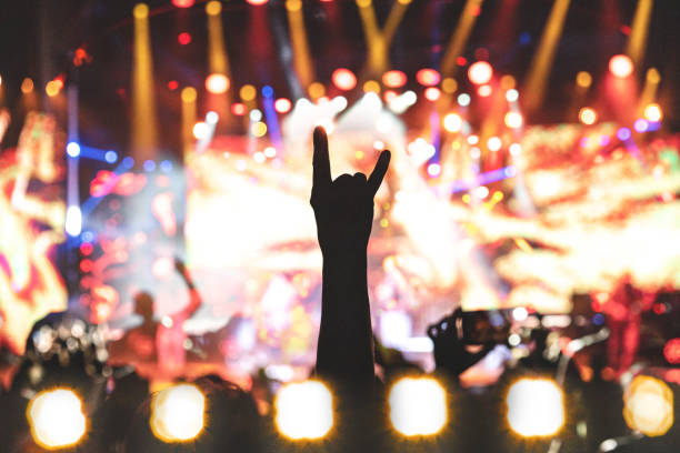rock concert, concert lights, concert audience cheering, concert hands raised, rock hands, rock on - concert stock pictures, royalty-free photos & images