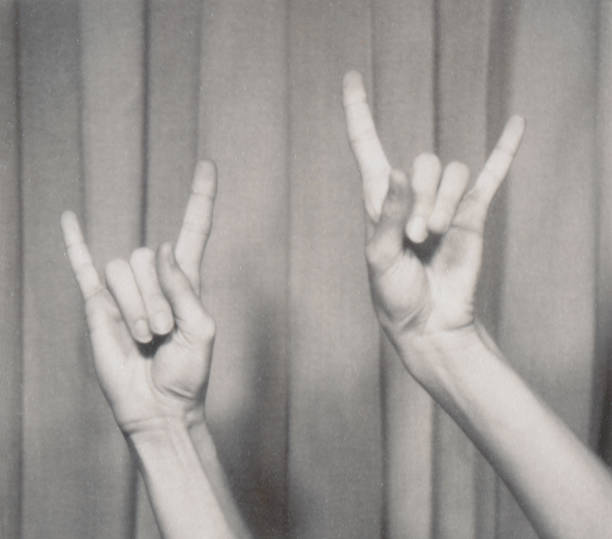 rock n roll hand symbol, gesturing music hand sign, horn sign hands music fan concert - concert stock pictures, royalty-free photos & images