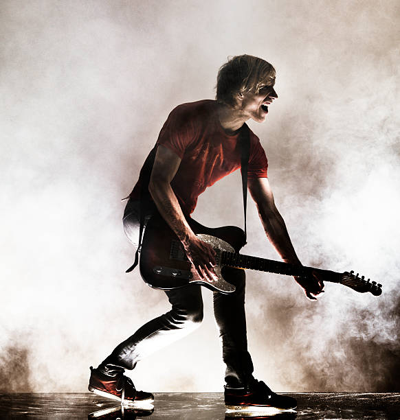 rock star with his guitar. - concert stock pictures, royalty-free photos & images