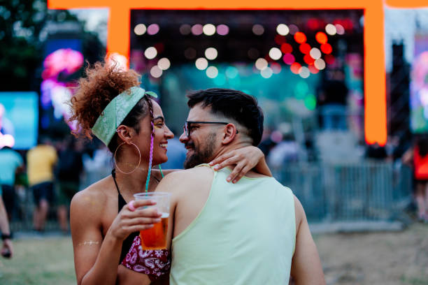 romantic hipster couple at music festival. - concert stock pictures, royalty-free photos & images