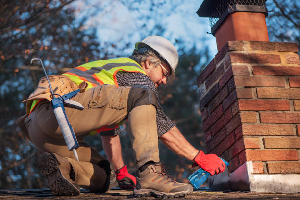 roofer sprays water on brick chimney. worker prepares cement application wearing white hard hat and safety gear - home decoration stock pictures, royalty-free photos & images