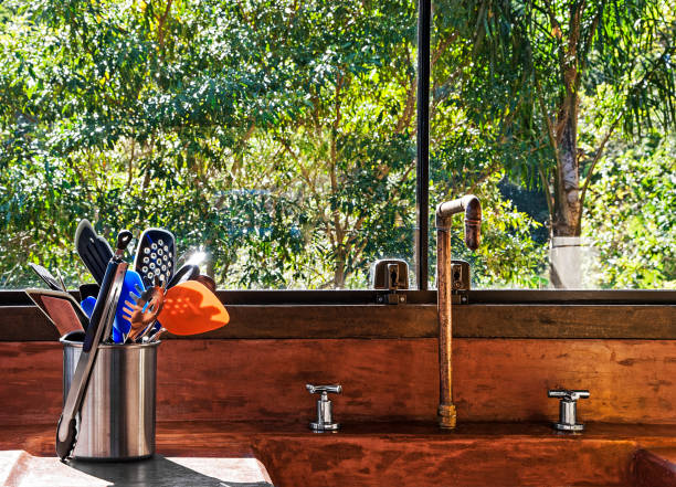 rustic kitchen with copper faucet and terracotta sink . still life - garden decoration stockfoto's en -beelden