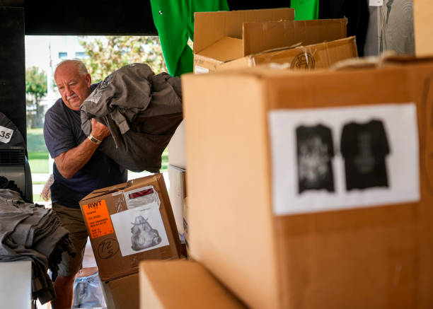 Sam Love unpacks Beyoncé merchandise as fans line up before the artists two weekend concerts at NRG Stadium, Saturday, Sept. 23 in Houston.
