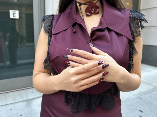 Samia Laaboudi wears a burgundy silk and lace top and skirt from L2R The Label, a burgundy orchid flower choker necklace from Kenza Klay, fantasy...