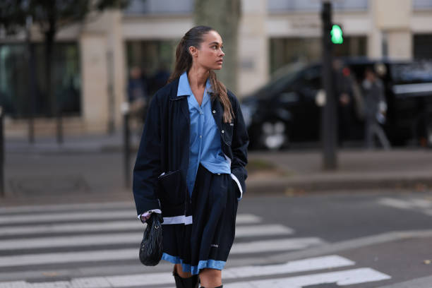 Sarah Lysander Svendby Carter is seen wearing a complete outfit from Miu Miu, consisting of a dark blue cardigan with collar featuring unfinished...