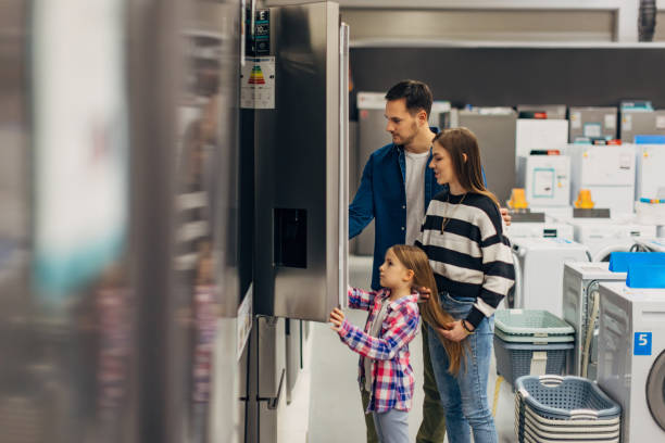 satisfied customers choosing fridge in domestic appliances section - home decoration stock pictures, royalty-free photos & images