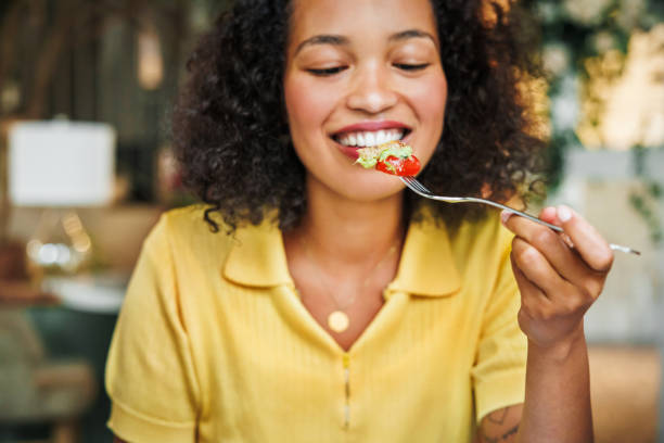 savoring a fresh salad bite - food stock pictures, royalty-free photos & images
