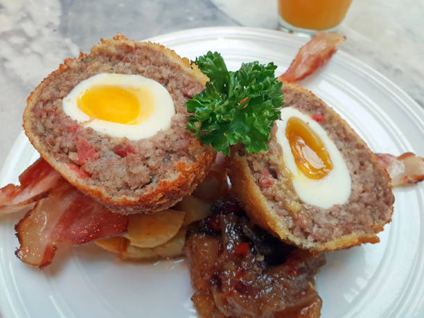 scotch eggs on bacon and caramelised onion - junk food stock pictures, royalty-free photos & images