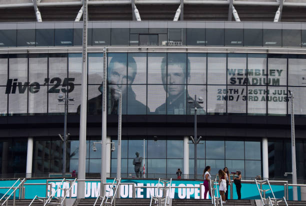 Screens at Wembley Stadium advertise the forthcoming gigs by Oasis, currently scheduled to play five nights in July and August 2025 at the famous...