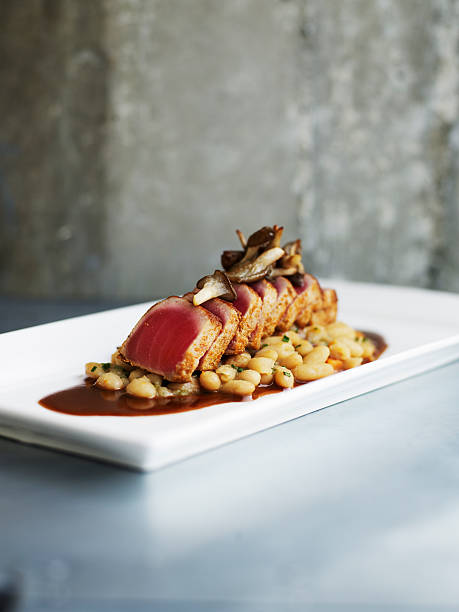 seared spiced tuna with cannellini beans - food stock pictures, royalty-free photos & images