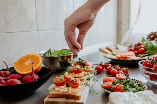 seasoning tasty bruscheta in the kitchen - food stock pictures, royalty-free photos & images