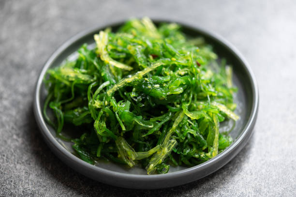 seaweed salad in black plate - food stock pictures, royalty-free photos & images