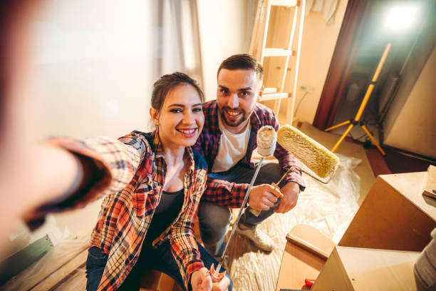 selfie break while painting house - home decoration stock pictures, royalty-free photos & images