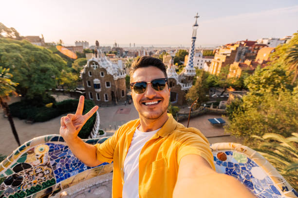 selfie of a young smiling man in sunglasses in barcelona, spain - travel stock pictures, royalty-free photos & images