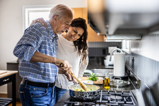 senior couple cooking in kitchen - food stock pictures, royalty-free photos & images