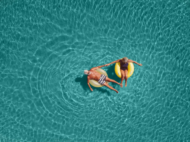 senior couple enjoy sea water - travel stock pictures, royalty-free photos & images