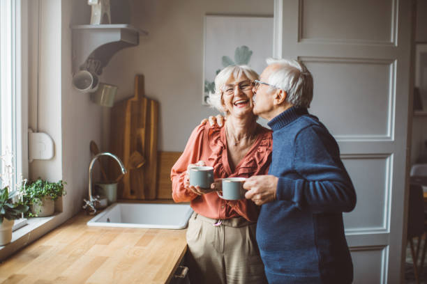 senior couple for christmas at home - coffee stockfoto's en -beelden