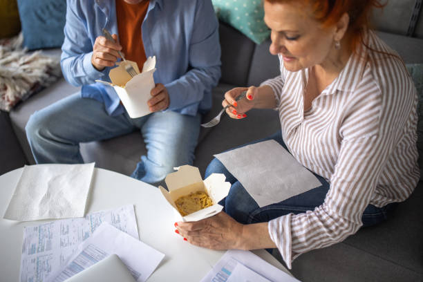 senior couple ordered pasta to eat at home - junk food stock pictures, royalty-free photos & images