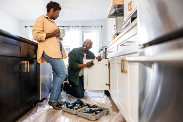 senior couple repairing kitchen cabinet at home - home decoration stock pictures, royalty-free photos & images