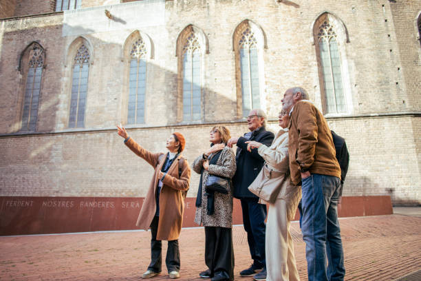 senior friends with a tour guide at the city - travel photos et images de collection