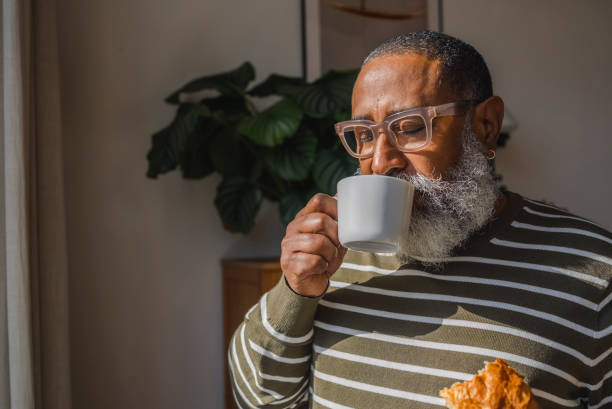senior hipster man drinking coffee in cup at home - coffee stock pictures, royalty-free photos & images