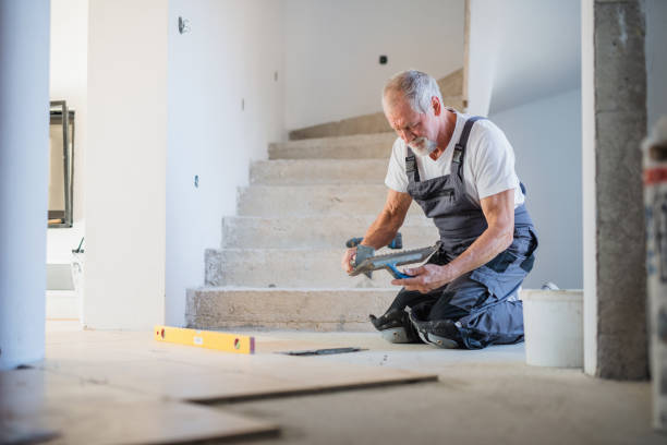 senior man laying tile floor in new home. - home decoration fotografías e imágenes de stock