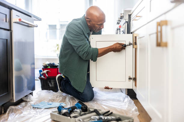senior man repairing kitchen cabinet at home - home decoration stock pictures, royalty-free photos & images
