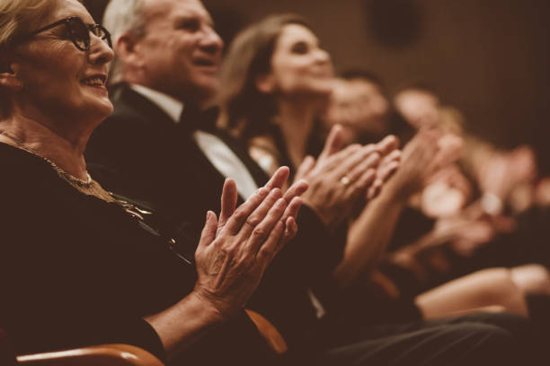 senior people clapping in the theater, focus on hands - concert stock pictures, royalty-free photos & images