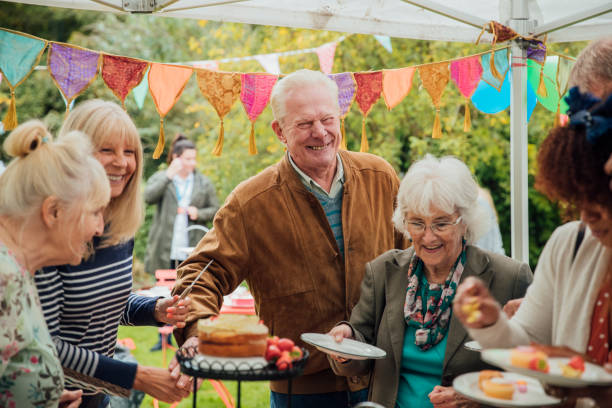 seniors enjoying cake - garden decoration stock pictures, royalty-free photos & images