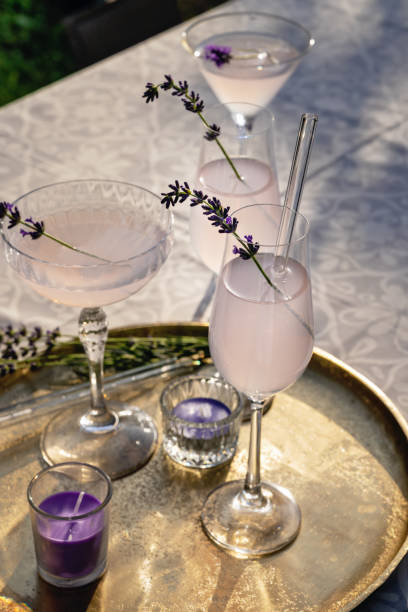 several cocktail glasses with lavender cocktail - garden decoration photos et images de collection