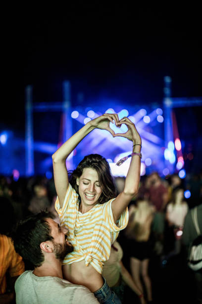 sharing some love on music festival! - concert stock pictures, royalty-free photos & images