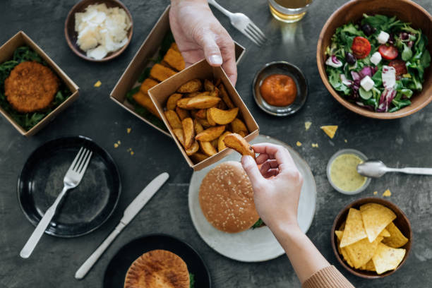 sharing takeaway fast-food meal - junk food stock pictures, royalty-free photos & images
