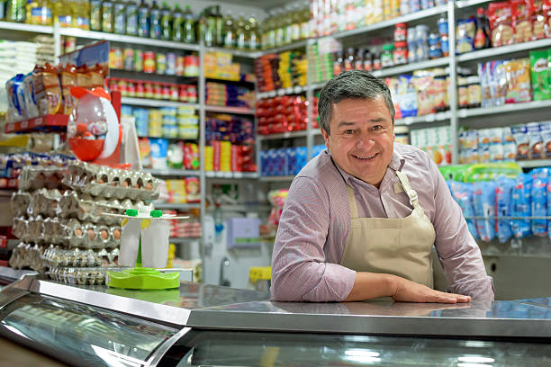 shopkeeper at a local food shop - food stock pictures, royalty-free photos & images
