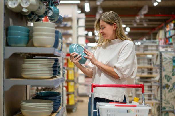 shopping woman buying plates at a department store - home decoration stock pictures, royalty-free photos & images