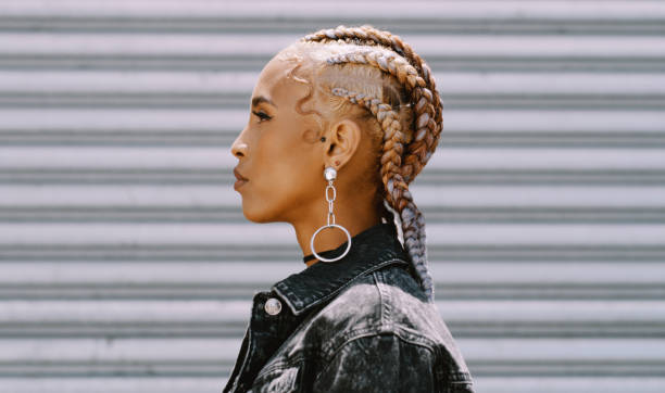 shot of a trendy young woman posing against a roll up garage door - hairstyle stock pictures, royalty-free photos & images
