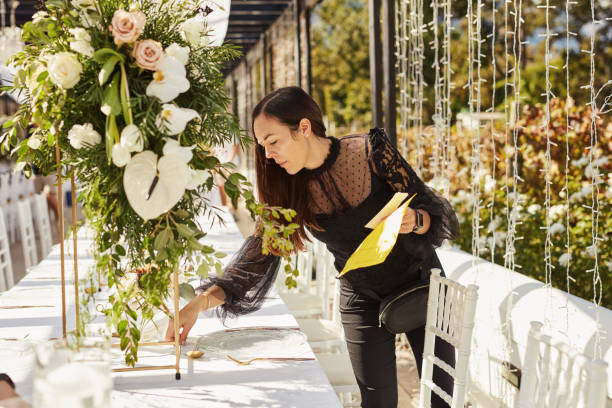 shot of a young woman decorating a table with place card holders in preparation for a wedding reception - garden decoration stock pictures, royalty-free photos & images