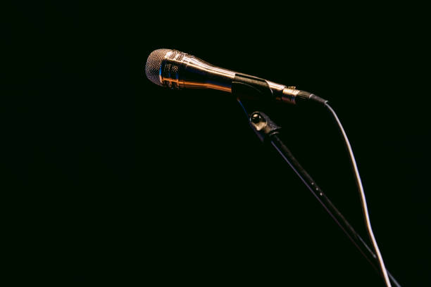 silver microphone stand with microphone on black background - concert stock pictures, royalty-free photos & images