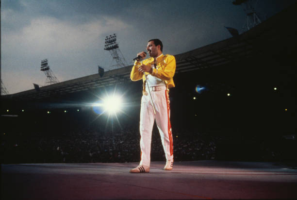 Singer Freddie Mercury performing with Queen at Wembley Stadium, London, July 1986. The band played two nights at the venue, as part of the Magic...