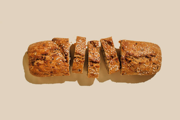 sliced bread on beige background. flat lay, top view, copy space - food stock pictures, royalty-free photos & images