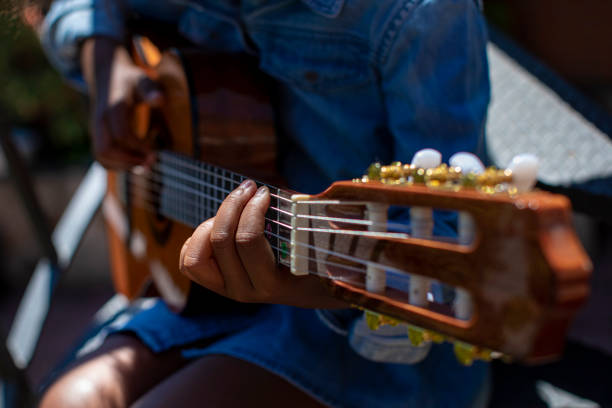 small girl learning to play the guitar - concert stock pictures, royalty-free photos & images
