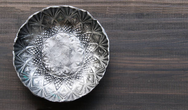 small textured metal plate on a wooden background - garden decoration stock pictures, royalty-free photos & images