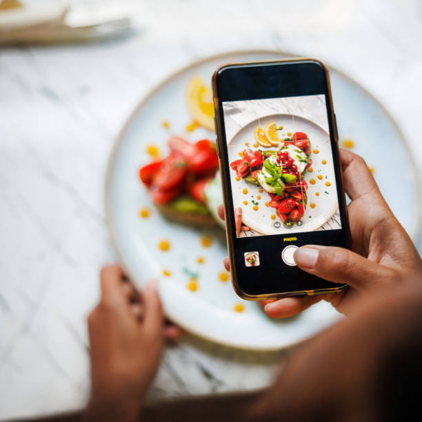 smartphone food photography in action - food stock pictures, royalty-free photos & images