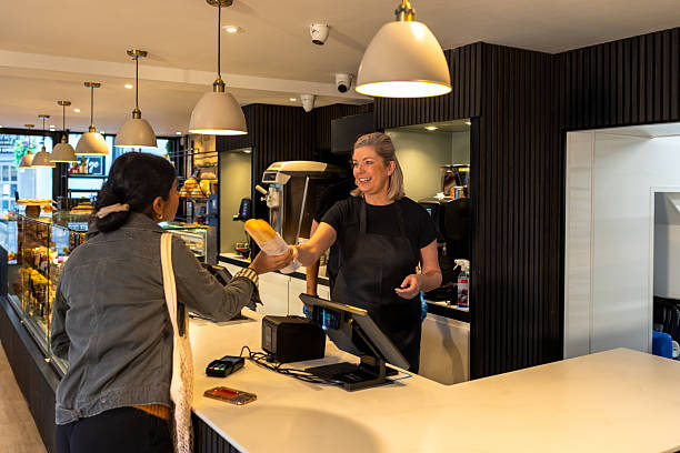 smiles and service at the pastry counter - junk food stock pictures, royalty-free photos & images