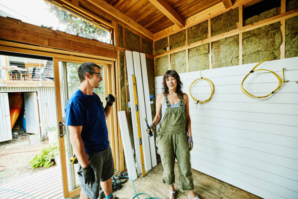 smiling couple working on improvement project - home decoration stock pictures, royalty-free photos & images