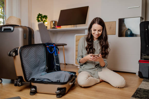 smiling woman using mobile phone - travel stock pictures, royalty-free photos & images