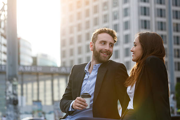 smiling young businesswoman and businessman outdoors - junk food stock pictures, royalty-free photos & images
