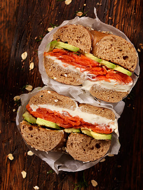 smoked salmon bagel with cream cheese and avocado - junk food stock pictures, royalty-free photos & images