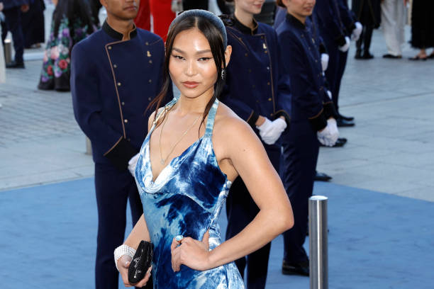 Snowboarder Chloe Kim poses during a photocall upon arrival to attend the Spring/Summer 2025 menswear ready to wear joint fashion show hosted by...