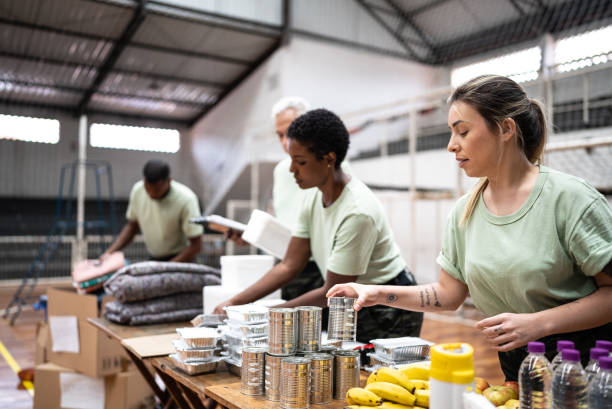soldiers organizing donations at a gymnasium - food stock pictures, royalty-free photos & images